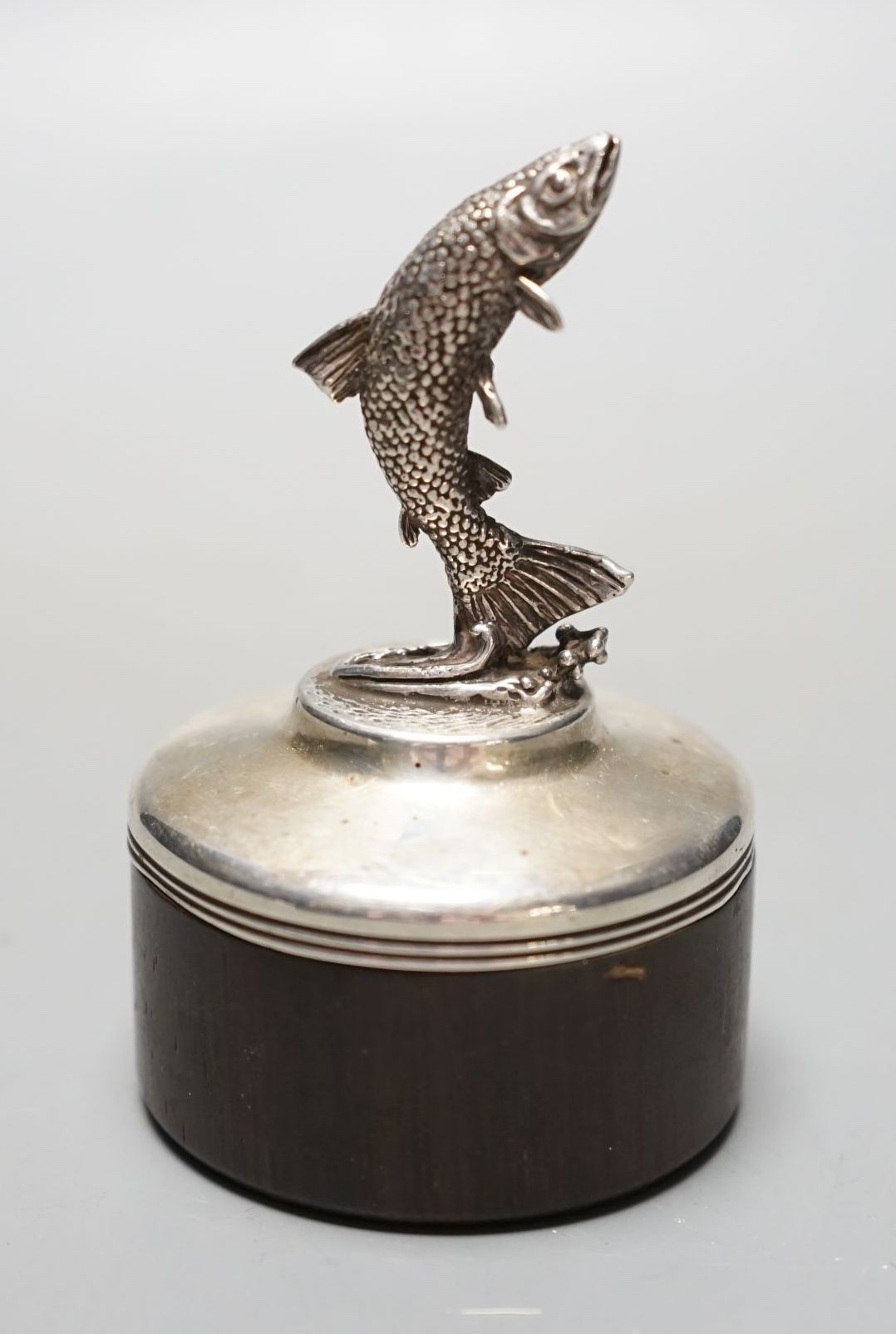 A modern silver mounted wooden box and cover by Brian Leslie Fuller box, with leaping salmon finial, London, 1990, height 85mm.